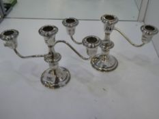 A pair of silver candleabras marked 'Lord Silver inc sterling weighted'