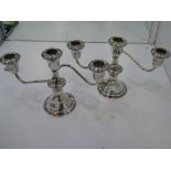 A pair of silver candleabras marked 'Lord Silver inc sterling weighted'