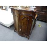 A Victorian mahogany two door cupboard having serpentine front with one long drawer, 96 cms,