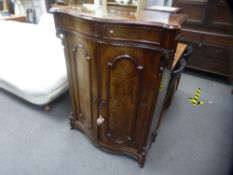 A Victorian mahogany two door cupboard having serpentine front with one long drawer, 96 cms,