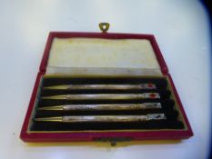 A cased set of four silver card game pencils engraved 'Made in England, Sterling silver'