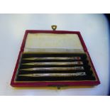 A cased set of four silver card game pencils engraved 'Made in England, Sterling silver'