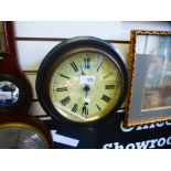 A small Victorian circular wall clock in ebonised case, 26 cms