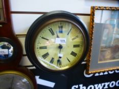 A small Victorian circular wall clock in ebonised case, 26 cms