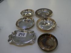 A silver lot of dishes of various hallmarks. Some engraved. Two dishes with coins included, one