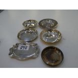 A silver lot of dishes of various hallmarks. Some engraved. Two dishes with coins included, one