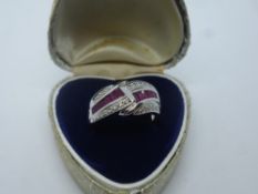 Modern 9ct white gold ruby and diamond crossover ring, marked 375, size Q/P
