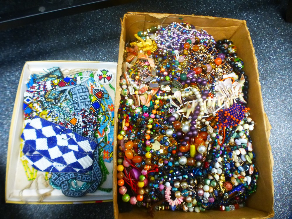 A tray of beadwork jewellery and a box of costume jewellery