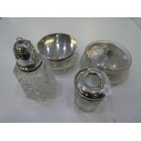 A silver lot comnprising of silver lidded dressing table set and a silver lidded sugar sifter with