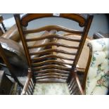 An Edwardian inlaid armchair having shaped ladderback, an oak chair with rush seat and a