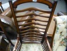 An Edwardian inlaid armchair having shaped ladderback, an oak chair with rush seat and a