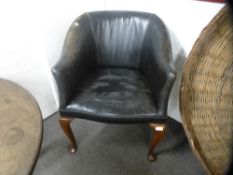 An old black leather desk chair on cabriole legs