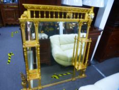 A late Victorian gilt overmantel mirror having side shelves iwth turned suppoorts and bevelled glass