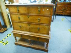 A late 19th/early 20th century chest on stand, having rosewood crossbanding and inlaid top, on