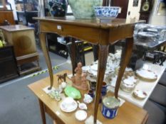 An antique French fruitwood side table, having a long drawer on carved cabriole legs, 78.5 cms