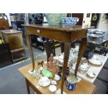 An antique French fruitwood side table, having a long drawer on carved cabriole legs, 78.5 cms