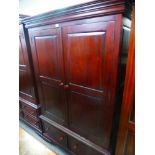 A modern mahogany style two door wardrobe with two lower drawers, 122 cms