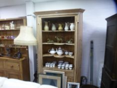 An antique pine barrel back corner cupboard having four open shelves, width 115cms
