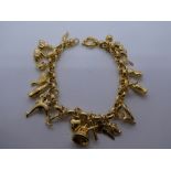 9ct yellow gold charm bracelet, containing many yellow metal charms, weight approx 17g