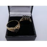 Two 9ct yellow gold dress ring, one set with four central black stone and cubic zirconia to the
