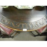 An antique oak oval gateleg table the edge carved 'Give us this day our daily bread', 127 cms