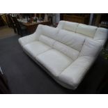 Two similar modern cream leather settees, on chrome legs, the largest 222 cms