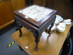 A Chinese hardwood square jardiniere stand having pierced frieze, with marble top, 42 cms