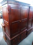 A modern mahogany style two door wardrobe, having four lower drawers, 121 cms