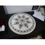 A modern circular marble top decorated flowers, 58.5 cms