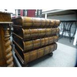 A reproduction hardwood chest of four drawers in form of stacked books on turned feet, 63.5 cms