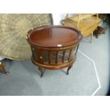 A reproduction oval drinks cabinet having two doors with removeable tray - 72.5 cms