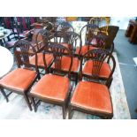 A set of eight early 20th century mahogany dining chairs having pierced splats, decorated