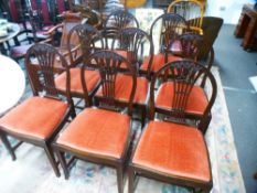 A set of eight early 20th century mahogany dining chairs having pierced splats, decorated