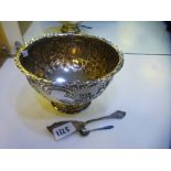 An ornate silver punch bowl with embossed foliate design hallmarked London 1901, maker's mark