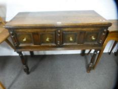 An old oak dresser base having two drawers on turned front legs, 105 cms