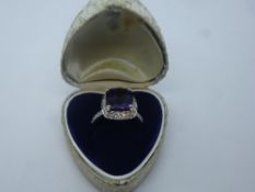 Contemporary 14K white gold dress ring, with cushion faceted amethyst surrounded by 34 brilliant cut