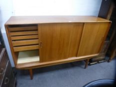 Clausen and Son, 1960s a Danish teak sideboard having three sliding doors, the interior fitted