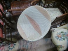 A vintage plastic woven satelitte chair on metal legs