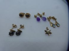 Four pairs of 9ct yellow gold earrings including pair of garnet studs, amethyst drop and