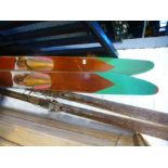 A pair of vintage wooden water skis by Gilcraft and a pair of vintage snow skis