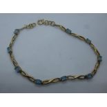 Pretty 9ct yellow gold bracelet set with 9 pale blue stones, marked 375, gross weight approx 5g