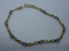 Pretty 9ct yellow gold bracelet set with 9 pale blue stones, marked 375, gross weight approx 5g