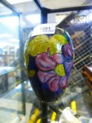 A MOORCROFT blue vase, decorated flowers, 13 cms.