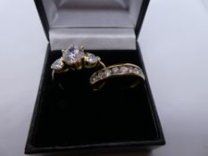 Two 9ct yellow gold dress rings set with cubic zirconias, marked 375, size P/Q. 5.2g