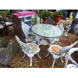 A set of four Victorian cast iron garden chairs and a Britannia cast iron table with circular marble