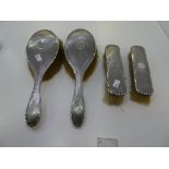 A silver dressing table set of four, consisting of all brushes. Having a central cartouche