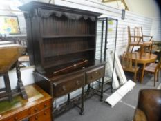 A 20th century oak dresser, with rackback, having two drawers on turned supports, 137 cms