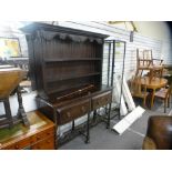 A 20th century oak dresser, with rackback, having two drawers on turned supports, 137 cms