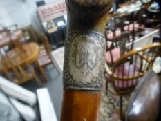 A Victorian malacca cane having silver mounts with horn handle