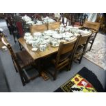 A reproduction oak refectory table on melon bulb legs and a set of six dining chairs, two with